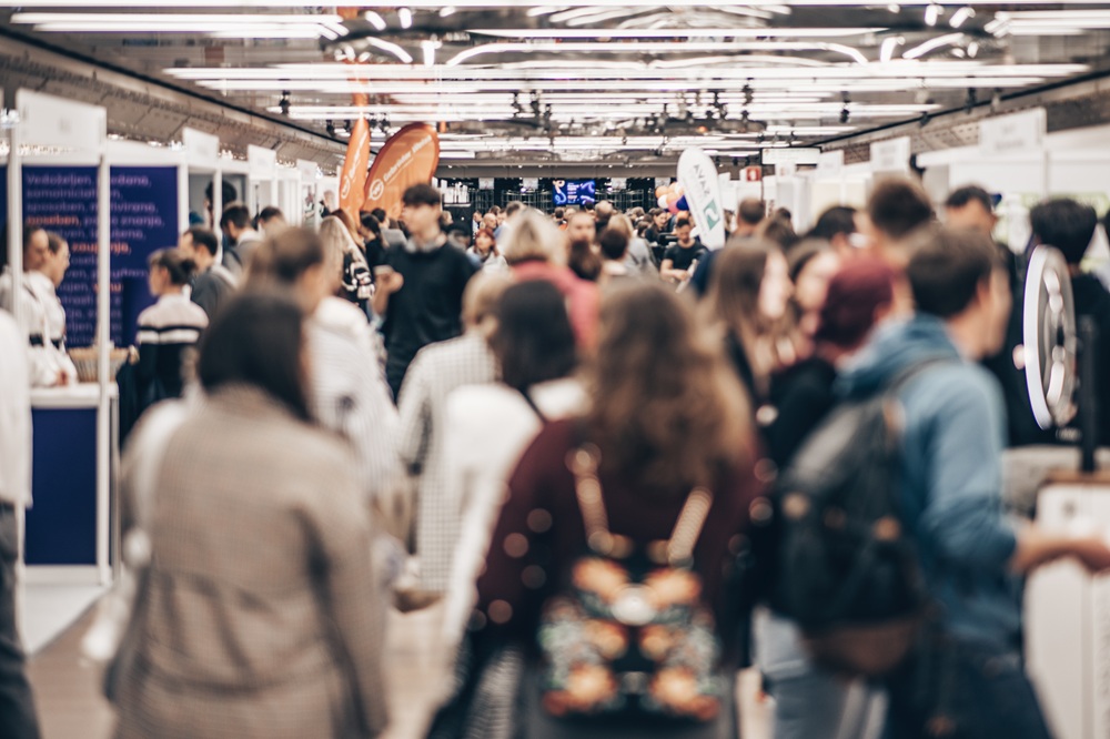 abstract blurred people at exhibition hall of expo event trade show. business convention show or job fair. business concept background.